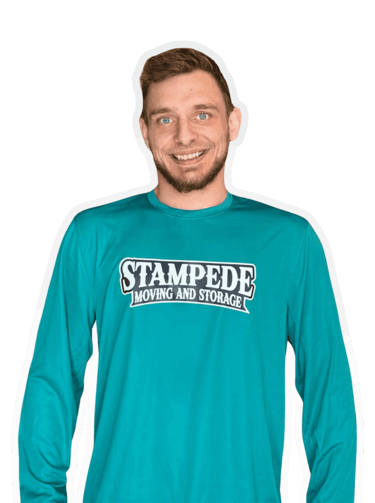 Man wearing Stampede Moving and Storage shirt, smiling.