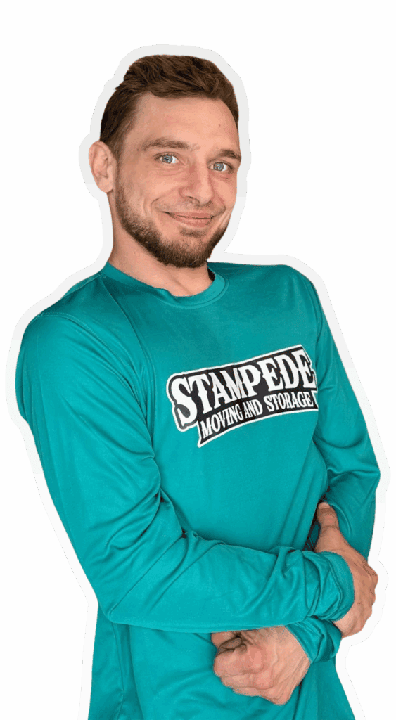 Person in Stampede Moving shirt smiling.