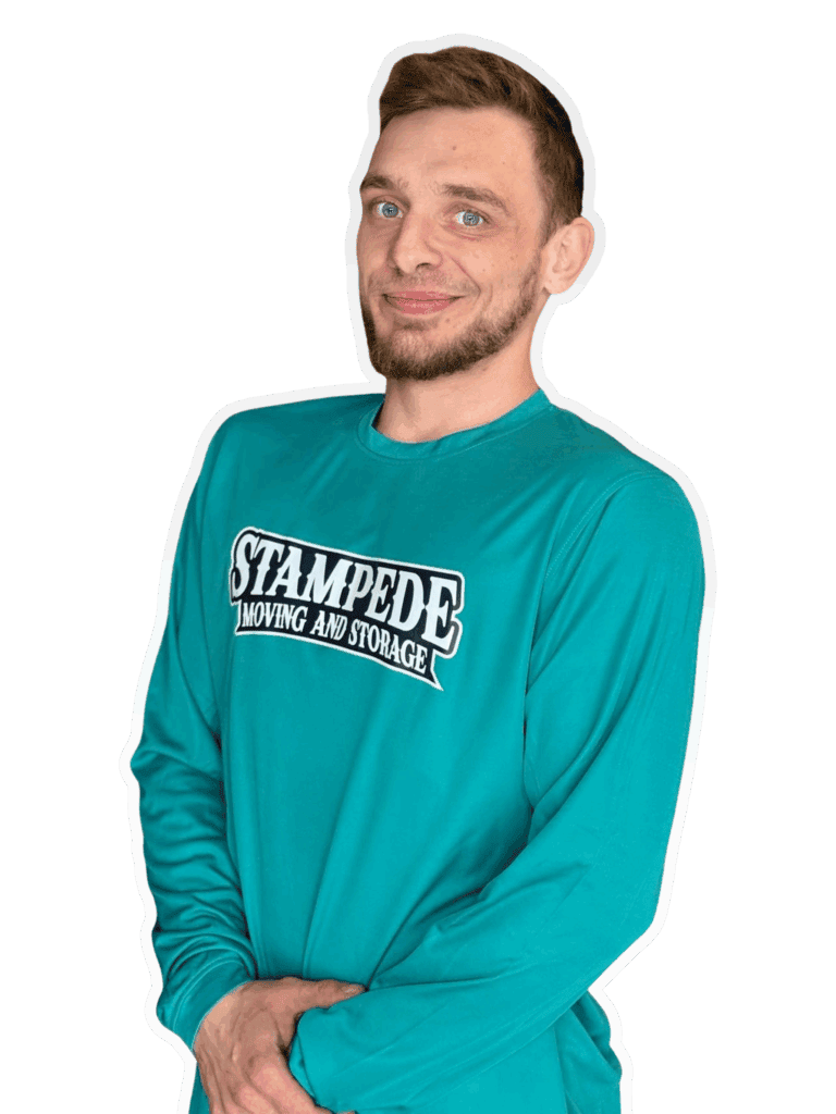 Smiling man in Stampede Moving shirt.