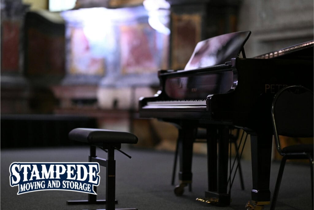 Grand piano under soft lighting in a room.