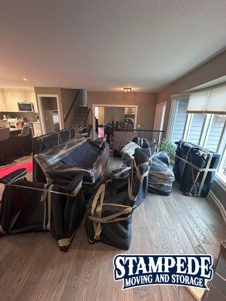 Living room with wrapped furniture ready for moving.