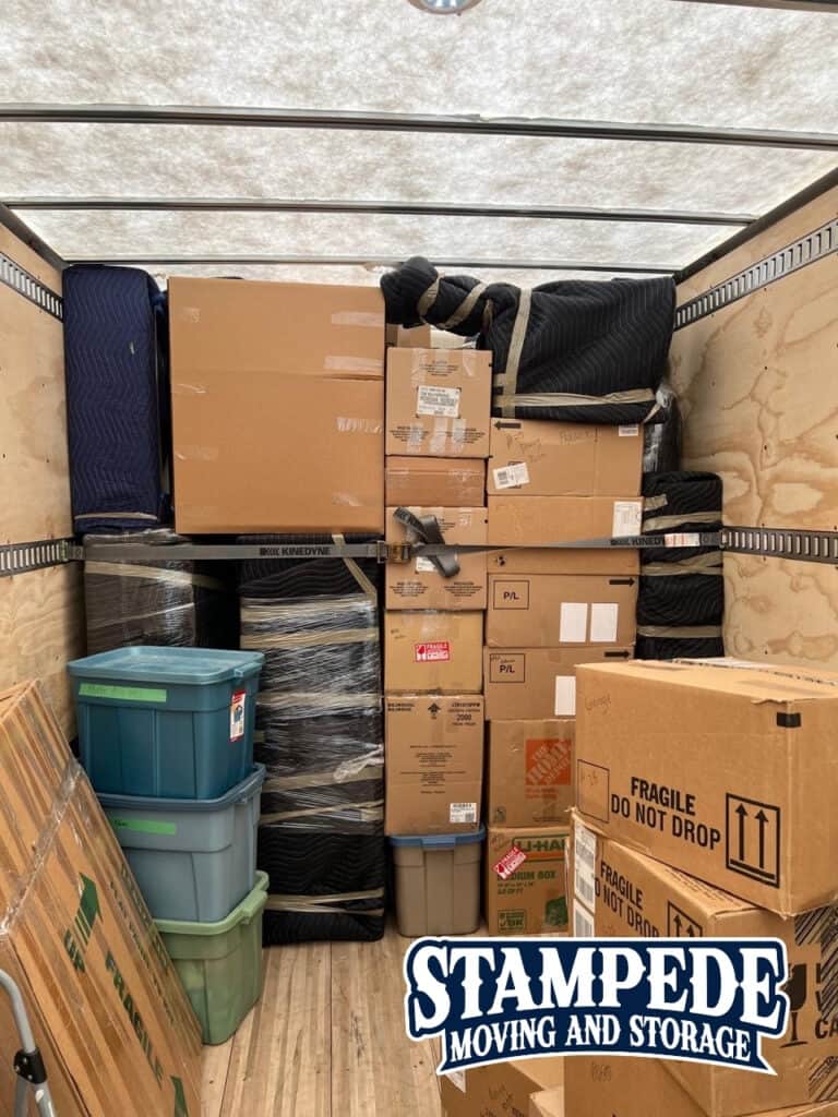 Moving truck filled with packed boxes and containers.