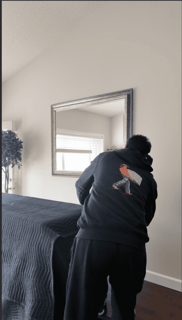 professional mover carefully protecting furniture with moving blankets, showcasing safe handling and reliable residential moving services