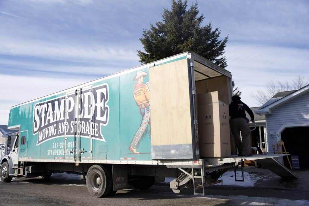 Moving truck parked outside house with loading ramp