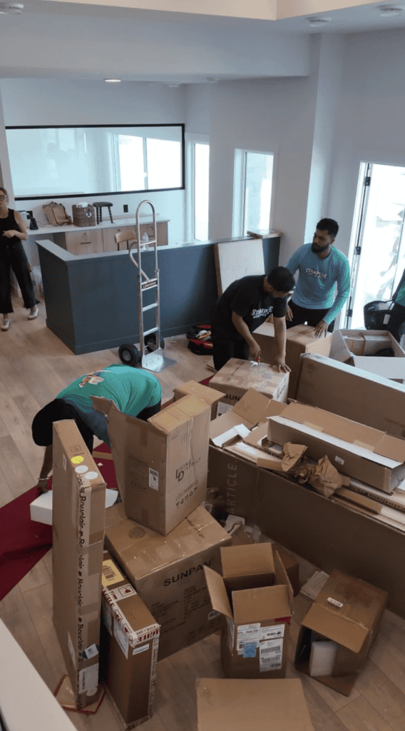 stampede moving & storage movers organize and pack household boxes inside a home, preparing belongings for a residential move